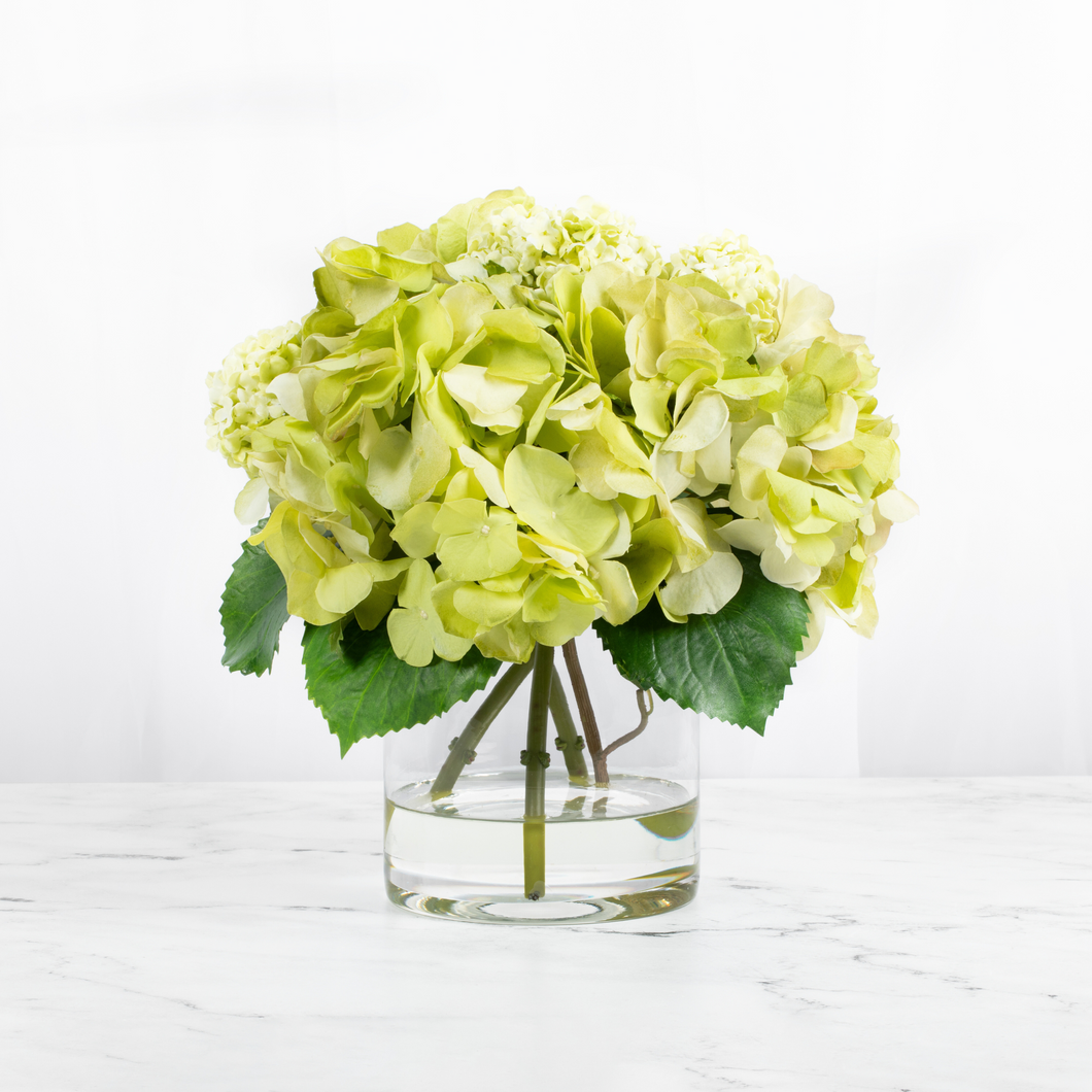 Silk hydrangea centerpiece arrangement in glass vase