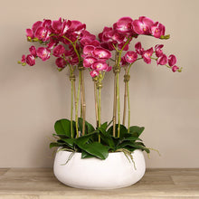 Load image into Gallery viewer, Artificial flower arrangement with pink orchids in white planter
